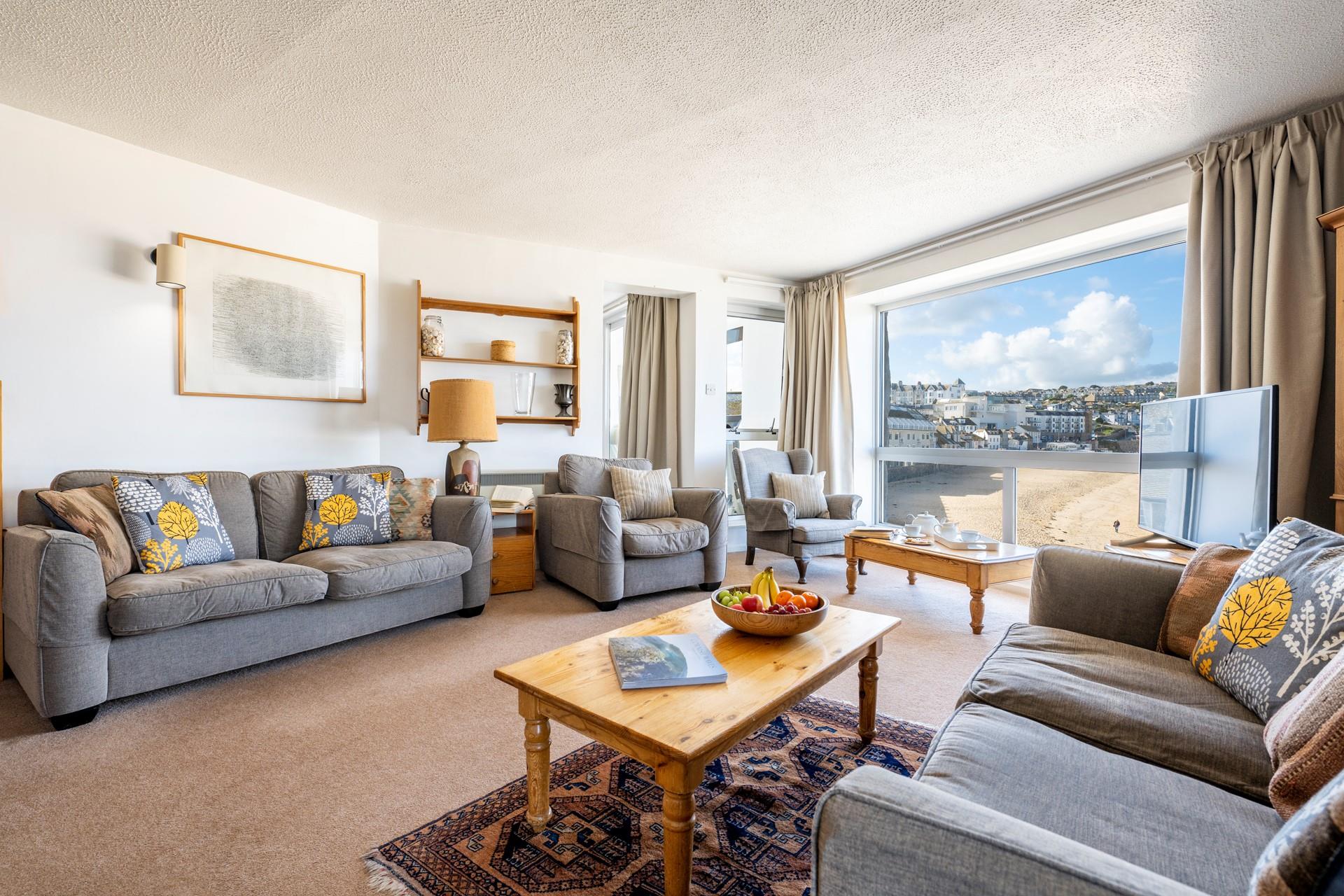 Bright dual aspect sitting room with uninterrupted views over Porthmeor. 
