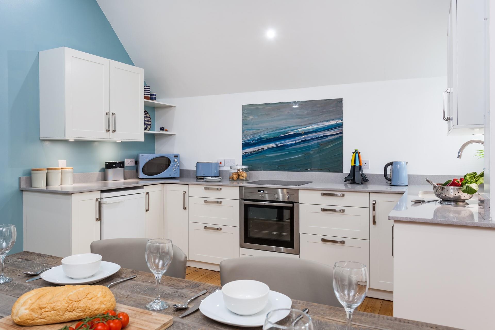 The well-equipped kitchen is spacious and modern.