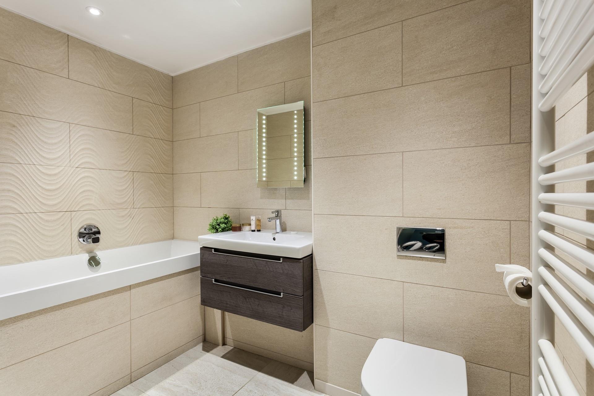 The bathroom boasts a relaxing, spa-like feel.