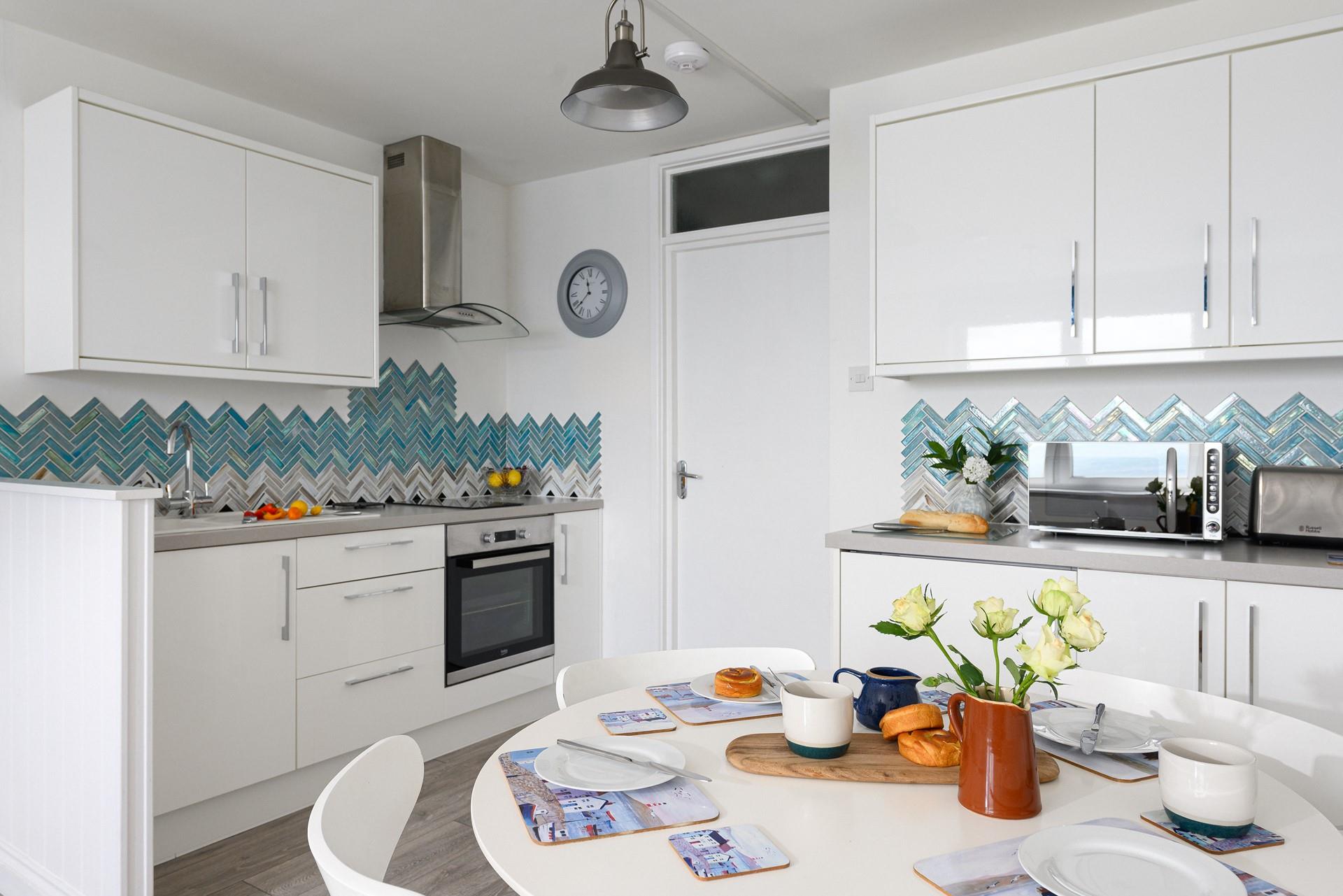 Though compact, the kitchen is fabulously well-equipped with modern appliances.