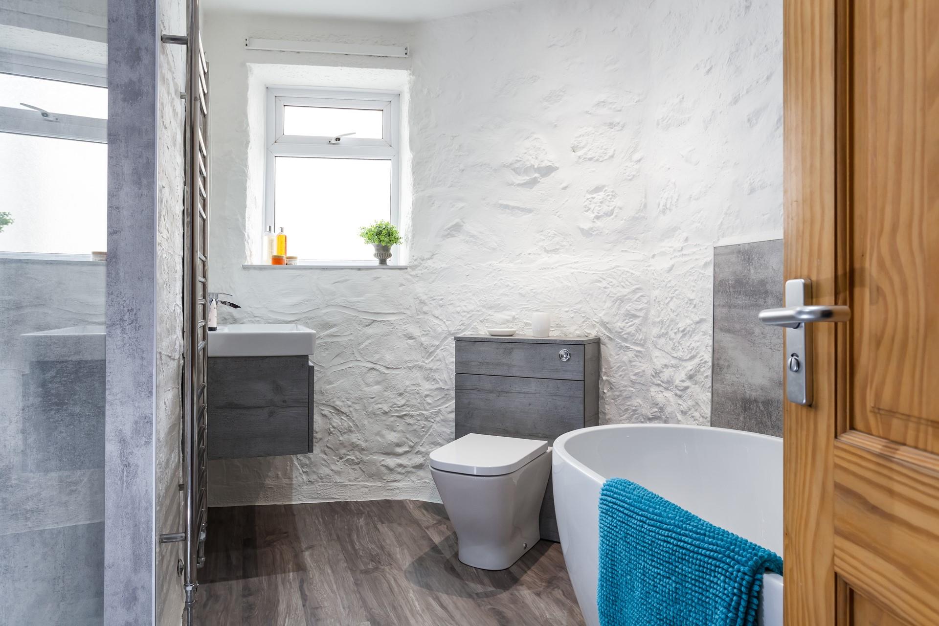 The bathroom is beautifully finished, perfect for relaxing after a day of coastal exploring.