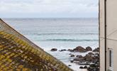 The sea view across the St Ives sea and the beach can be seen over the rooftops.  - Thumbnail Image