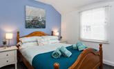 Bedroom 1 boasts coastal blue tones and Cornish artwork. - Thumbnail Image