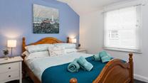 Bedroom 1 boasts coastal blue tones and Cornish artwork.