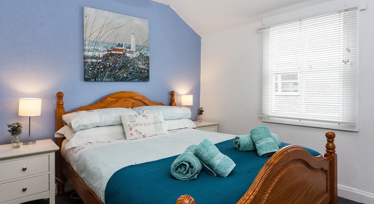 Bedroom 1 boasts coastal blue tones and Cornish artwork.