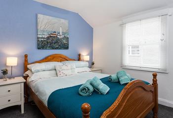 Bedroom 1 boasts coastal blue tones and Cornish artwork.