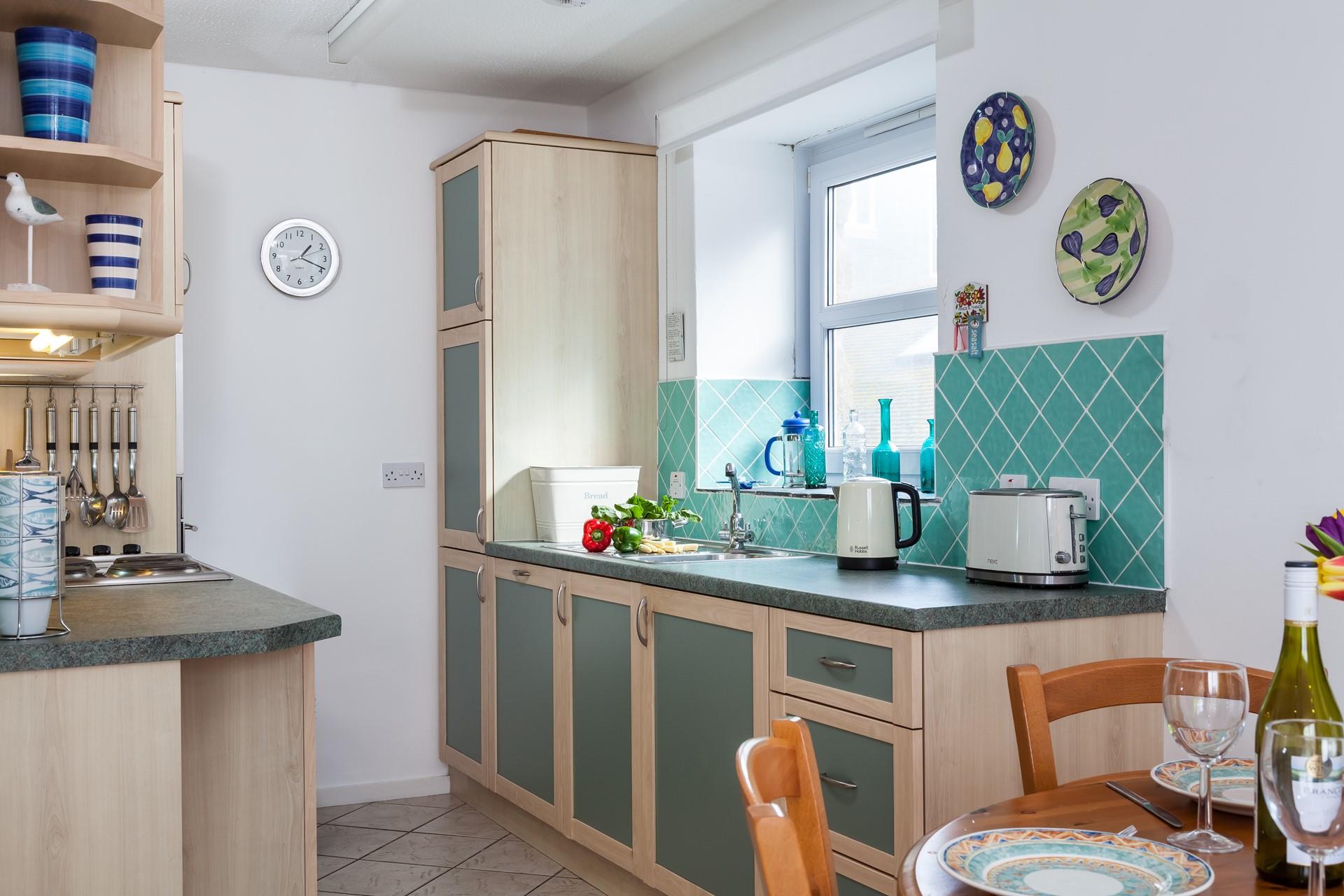 Bright and cheerful, the kitchen is well-equipped, making it easy to whip up delicious meals.