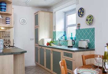 Bright and cheerful, the kitchen is well-equipped, making it easy to whip up delicious meals.