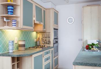 The kitchen has a unique colour scheme that is ideal for a seaside holiday.