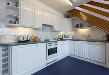 The stylish kitchen is well-equipped with modern appliances.