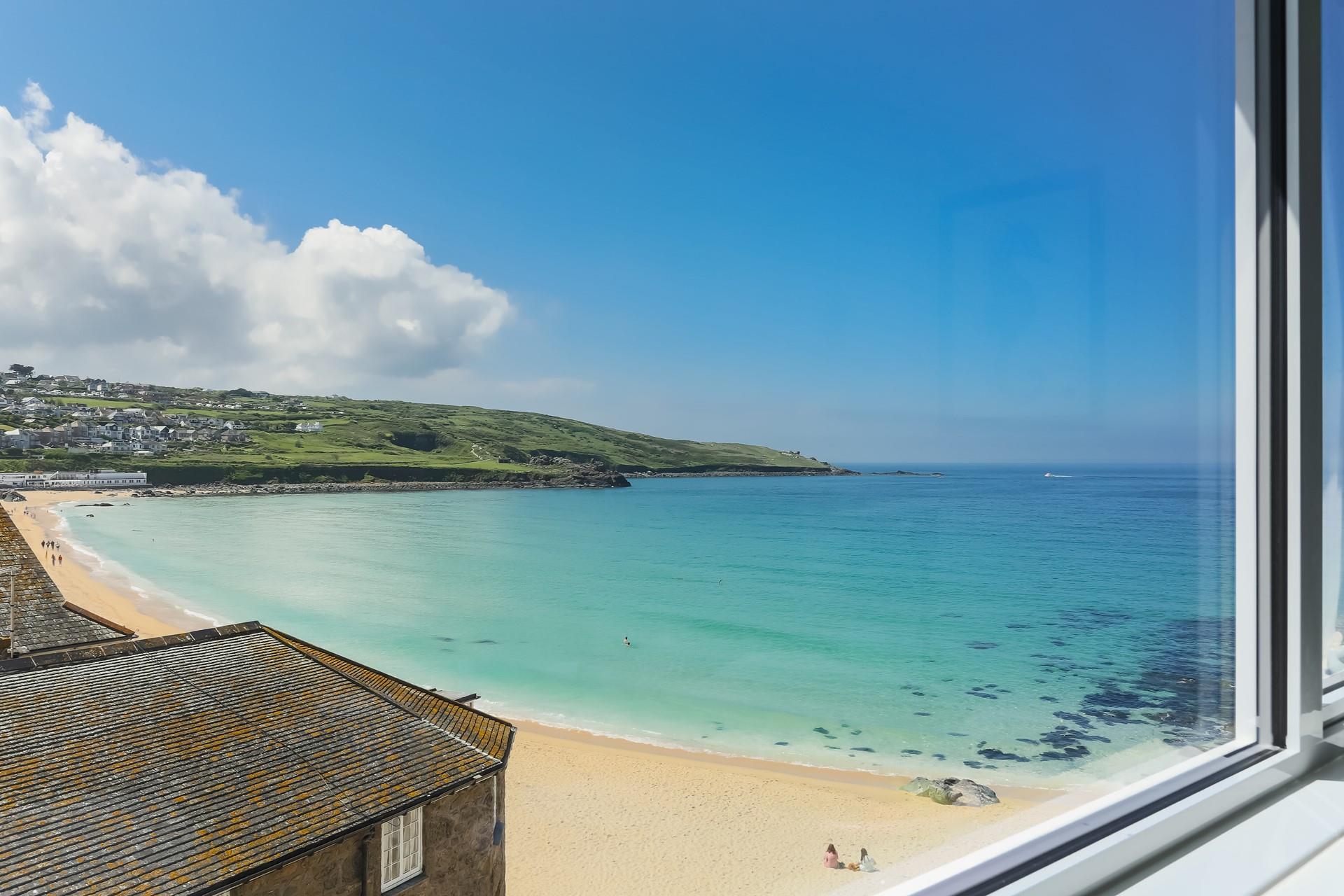 Large patio doors are perfect for letting in the fresh air and the sounds of the waves below.