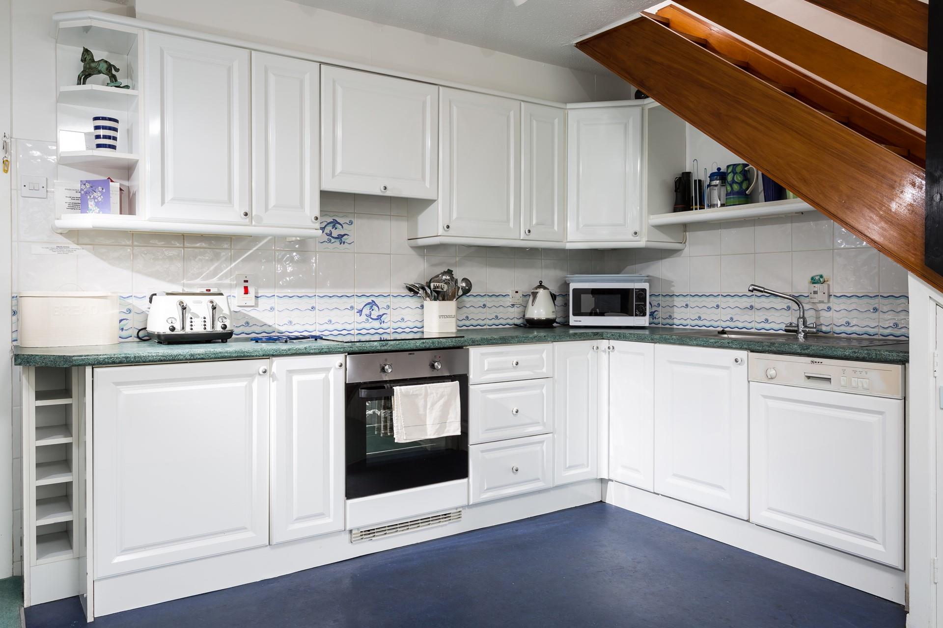 The stylish kitchen is well-equipped with modern appliances.