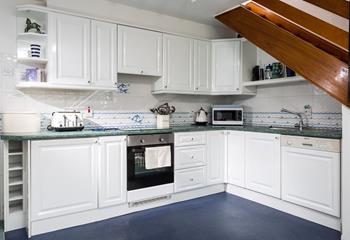 The stylish kitchen is well-equipped with modern appliances.