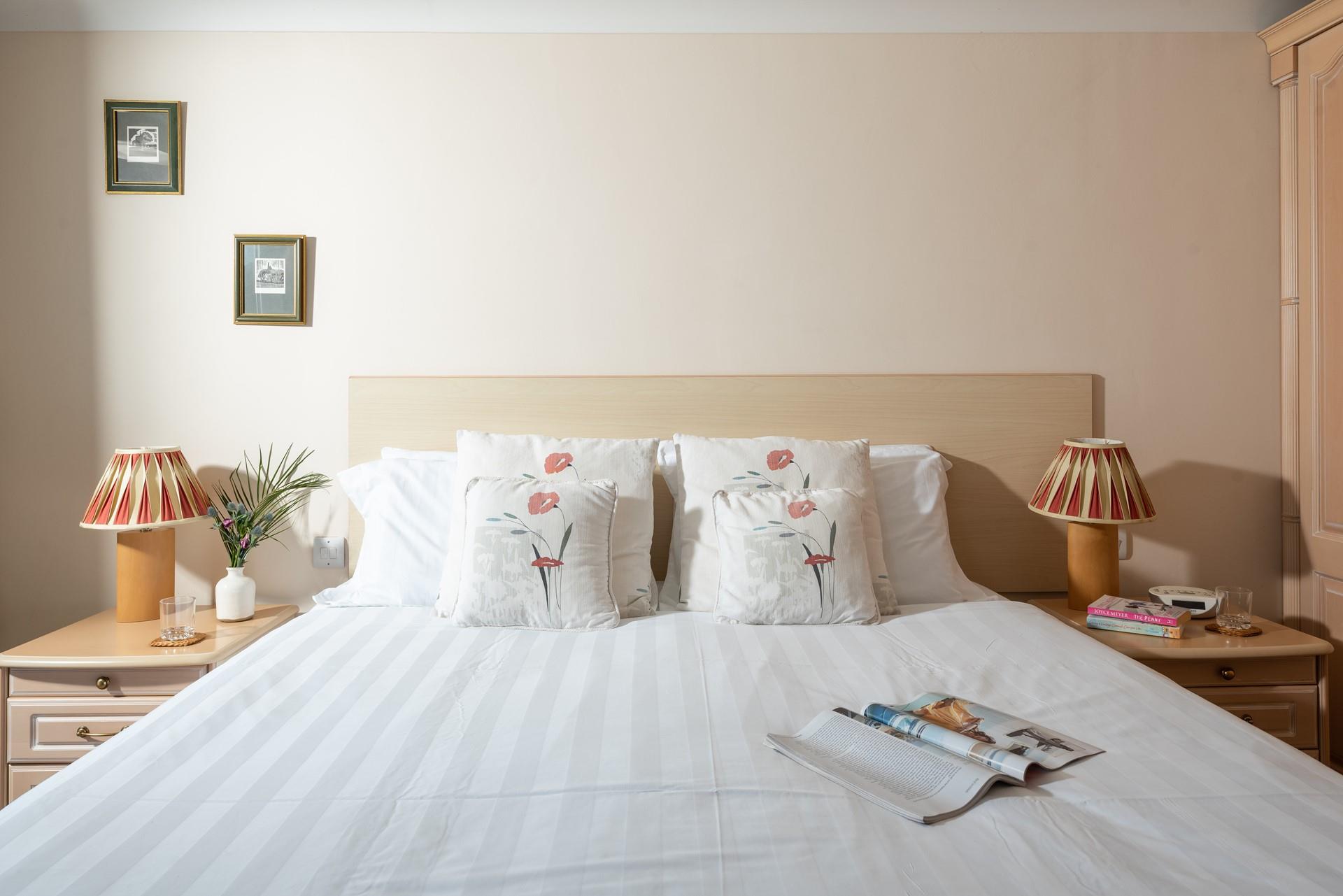 Crisp white linen and plump cushions make for a comfortable night's sleep. 