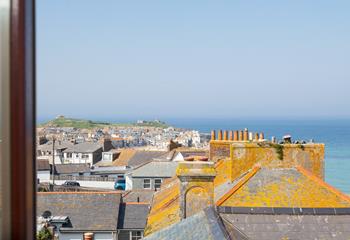 Look out over the rooftops to the sea sparkling in the distance.