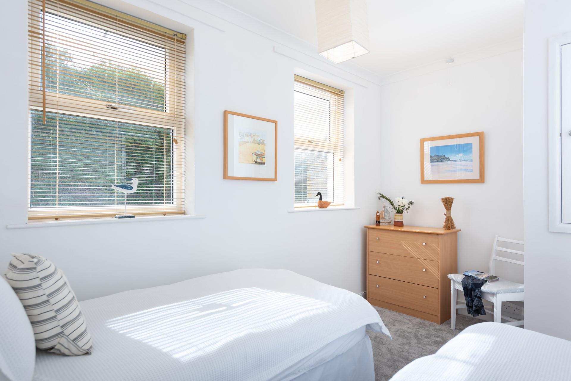 Large windows ensure the bedroom is a bright and pleasant space.