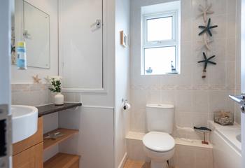 The charmingly decorated bathroom is perfect for rinsing the sand away after a day spent beachcombing. 