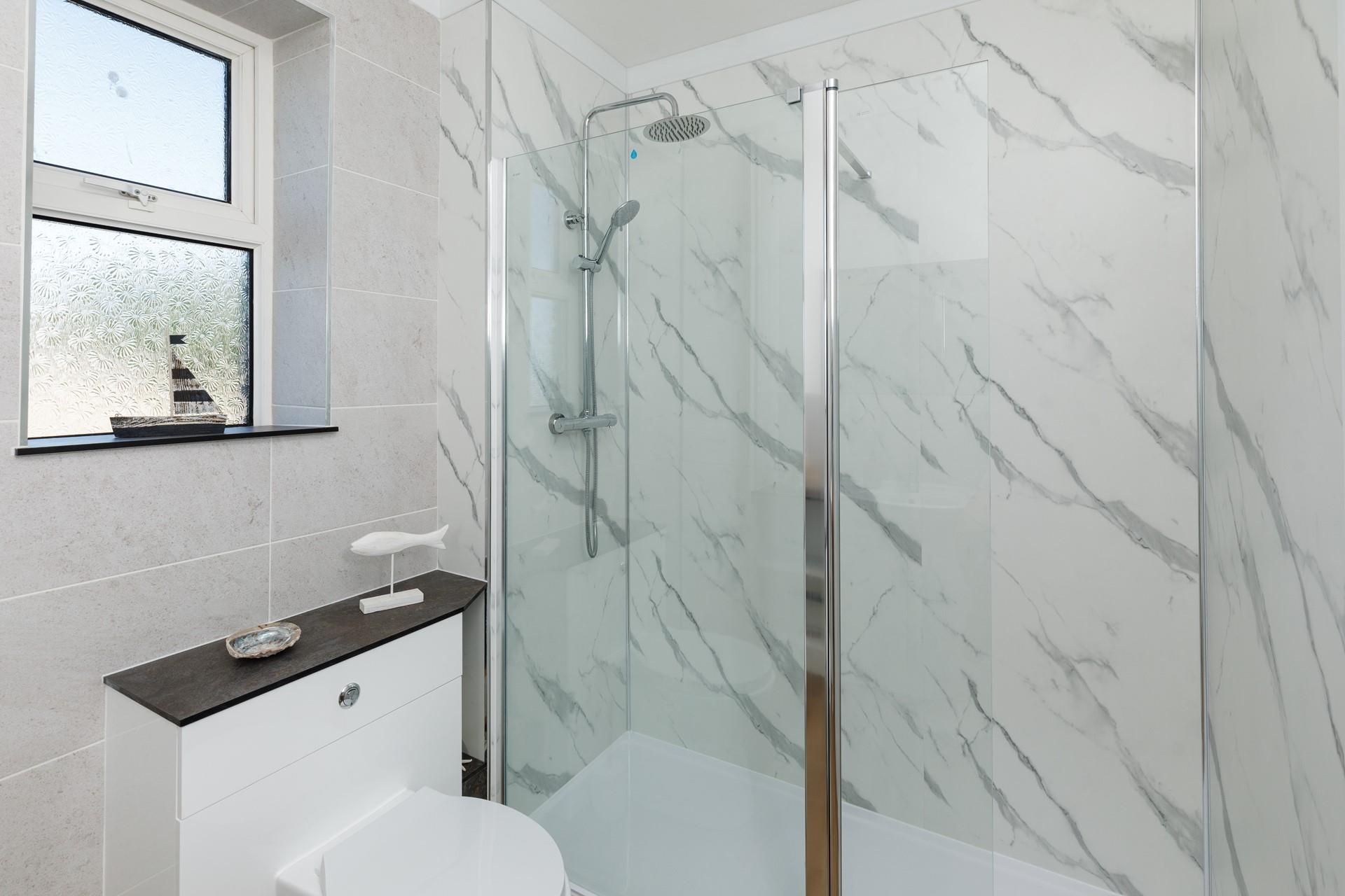 Step into the large walk-in shower for a rejuvenating rinse!