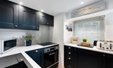 Though compact, the kitchen is fabulously well-equipped with all you could need and more. - Thumbnail Image