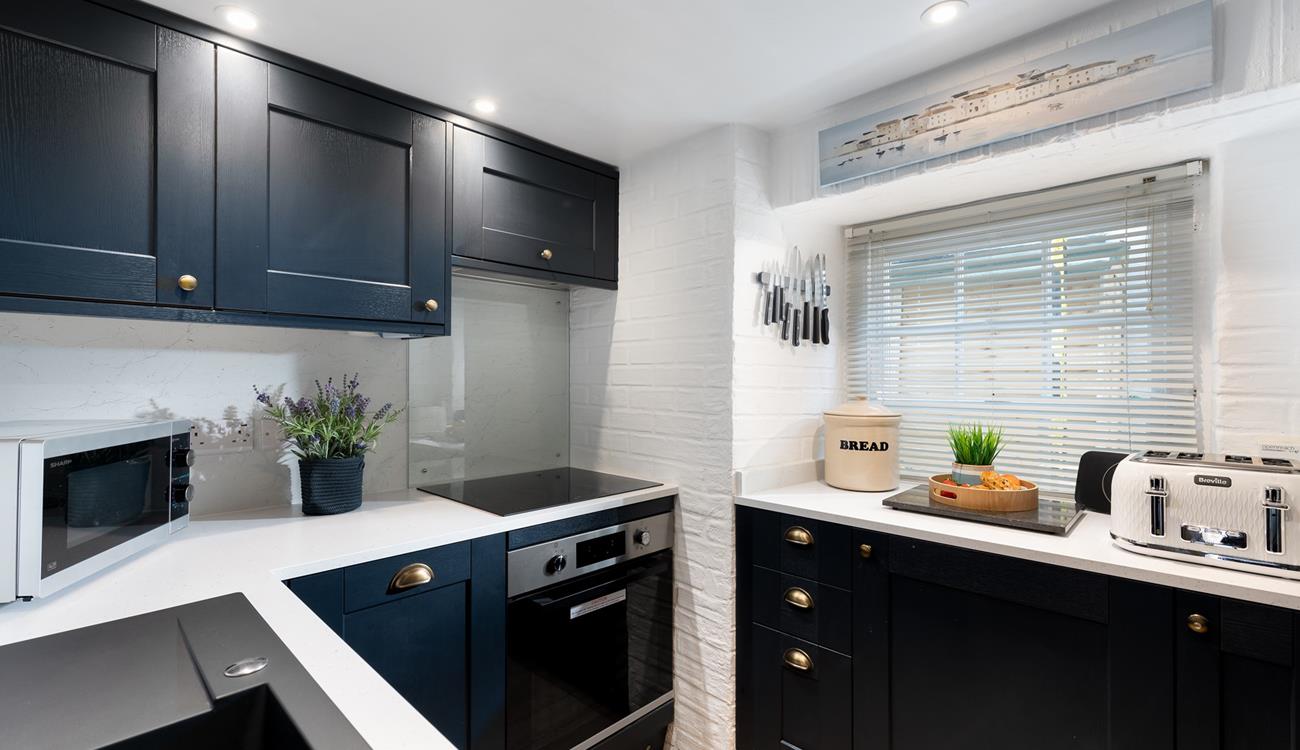 Though compact, the kitchen is fabulously well-equipped with all you could need and more.