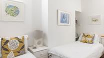 Calming hues and crisp white linen have created a light and inviting room.