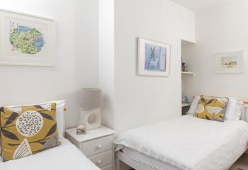 Calming hues and crisp white linen have created a light and inviting room.