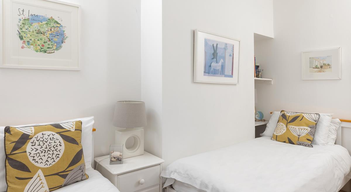 Calming hues and crisp white linen have created a light and inviting room.