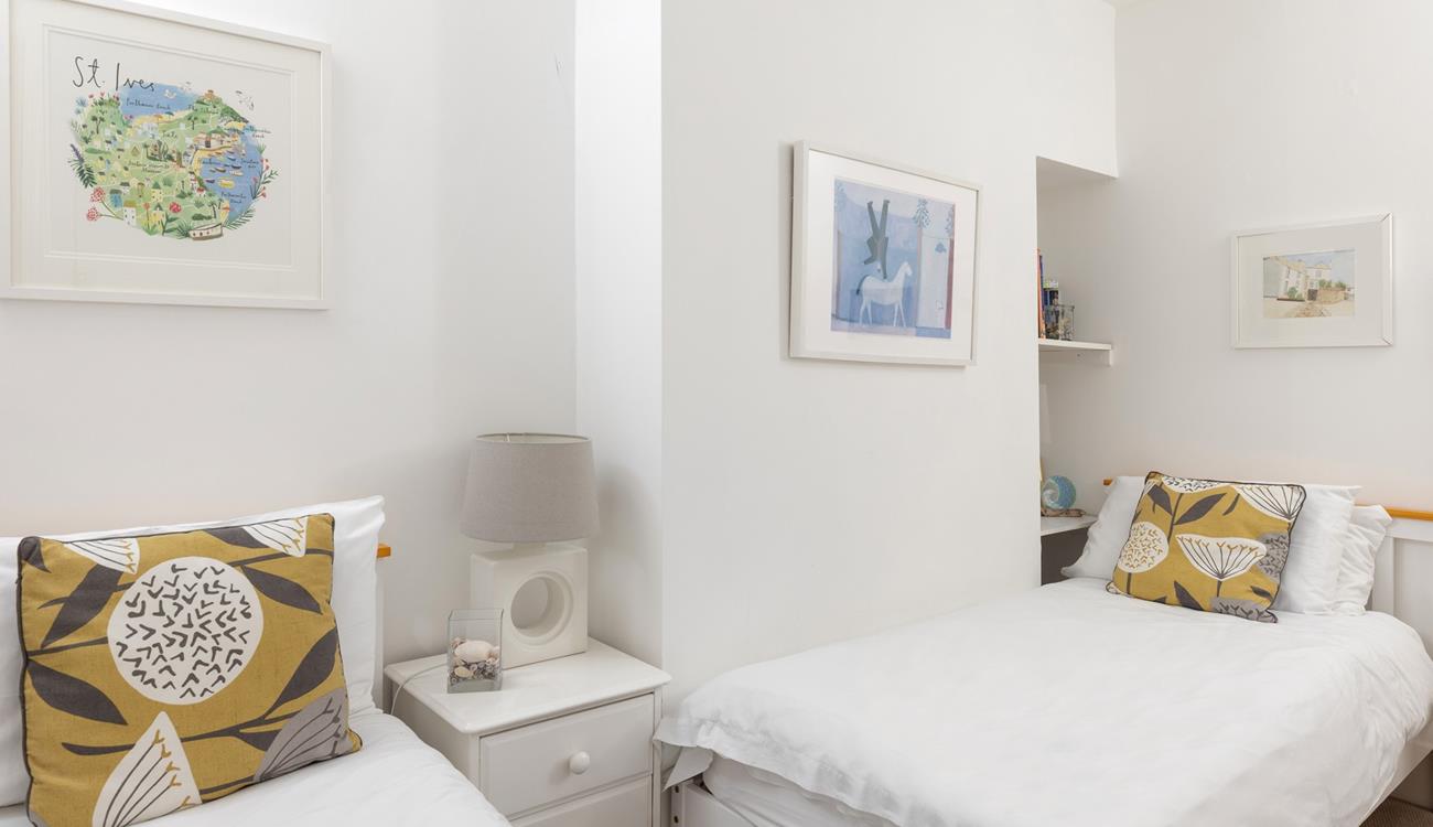 Calming hues and crisp white linen have created a light and inviting room.