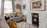 The cosy sitting room has lovely cottage features and woodburner for milder evenings. - Thumbnail Image
