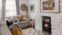 The cosy sitting room has lovely cottage features and woodburner for milder evenings.