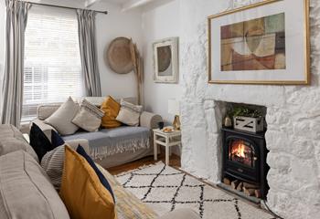 The cosy sitting room has lovely cottage features and woodburner for milder evenings.