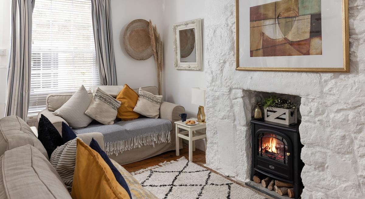 The cosy sitting room has lovely cottage features and woodburner for milder evenings.
