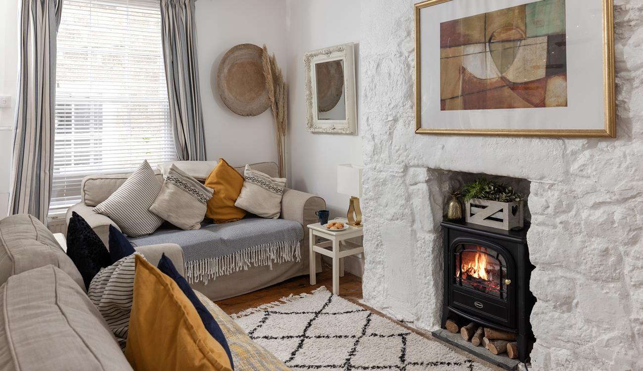 The cosy sitting room has lovely cottage features and woodburner for milder evenings.