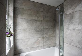 Marble tiles in calming tones are perfect for helping you to unwind in the bath.