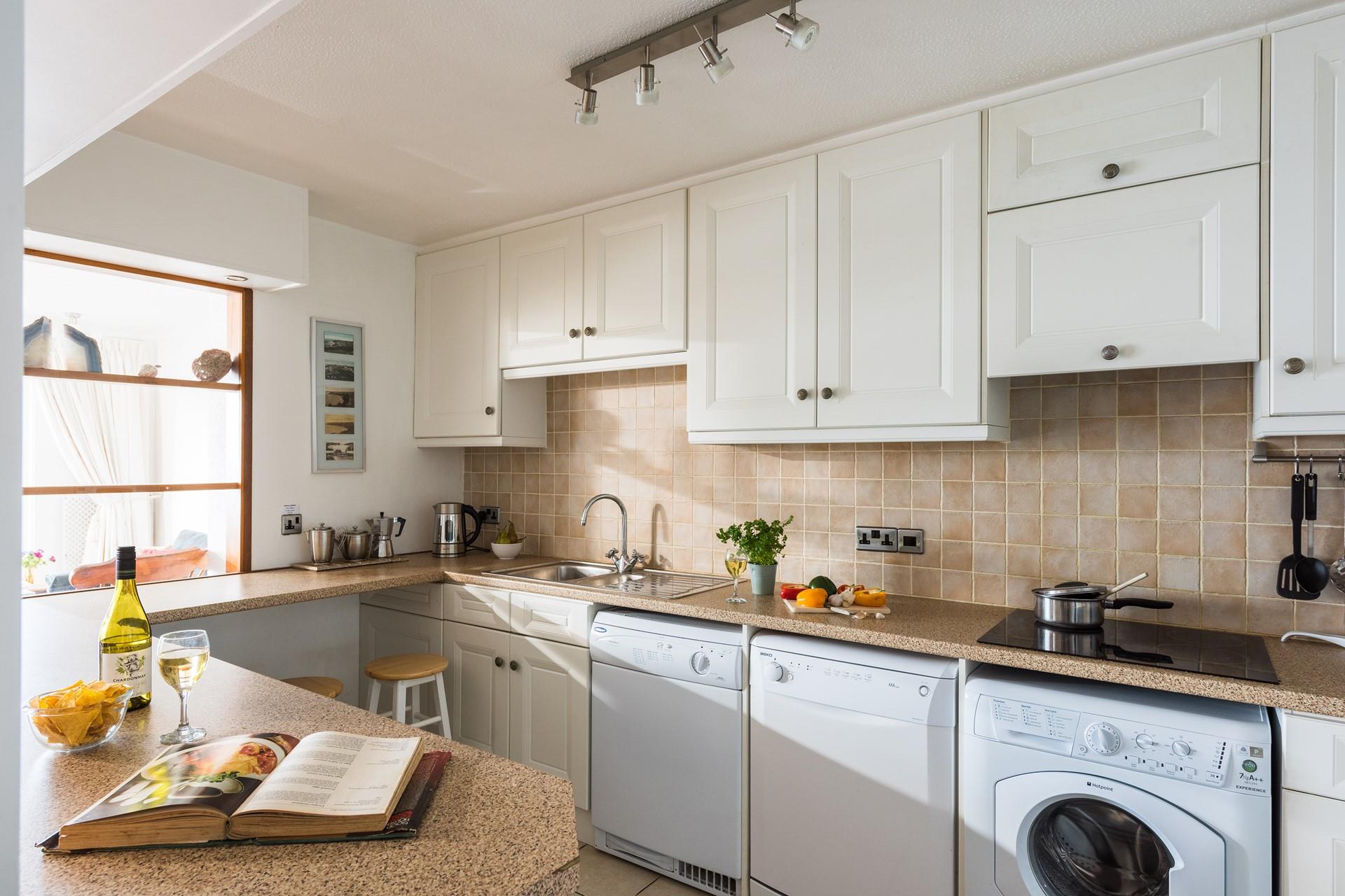The large kitchen has everything you need for your stay at Sea Blue. 