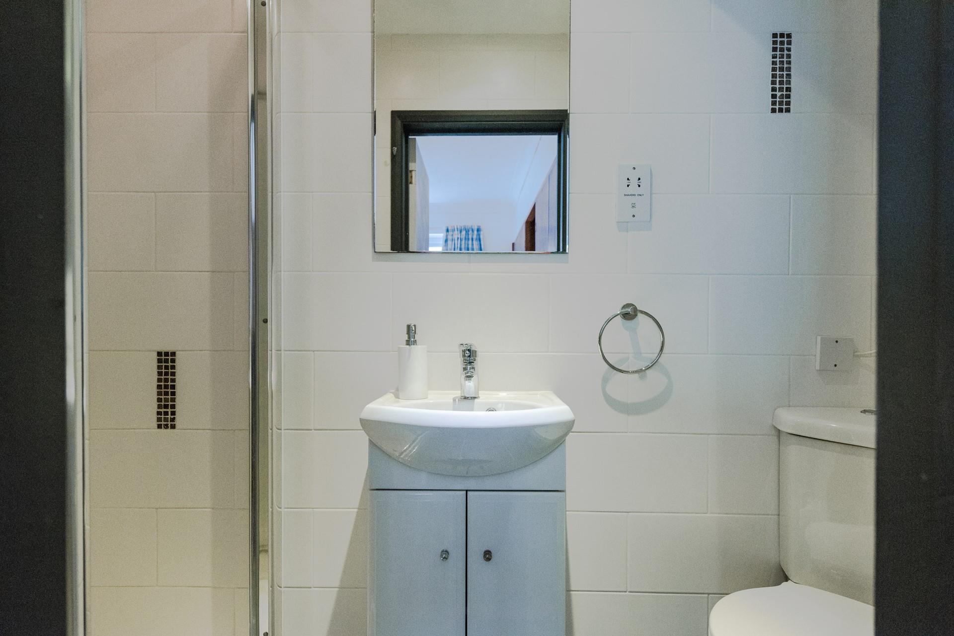 Bright and perfectly sized, the ensuite has an enclosed shower, WC and wash basin. 