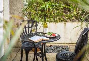 Dine outside at the bistro table and chairs on the private patio. 