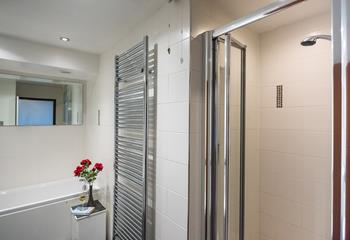 The large family bathroom features a separate bath and an enclosed shower. 