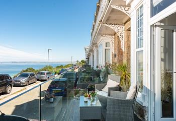 French doors lead out onto a small balcony area with views of Godrevy Lighthouse and St Ives Bay.