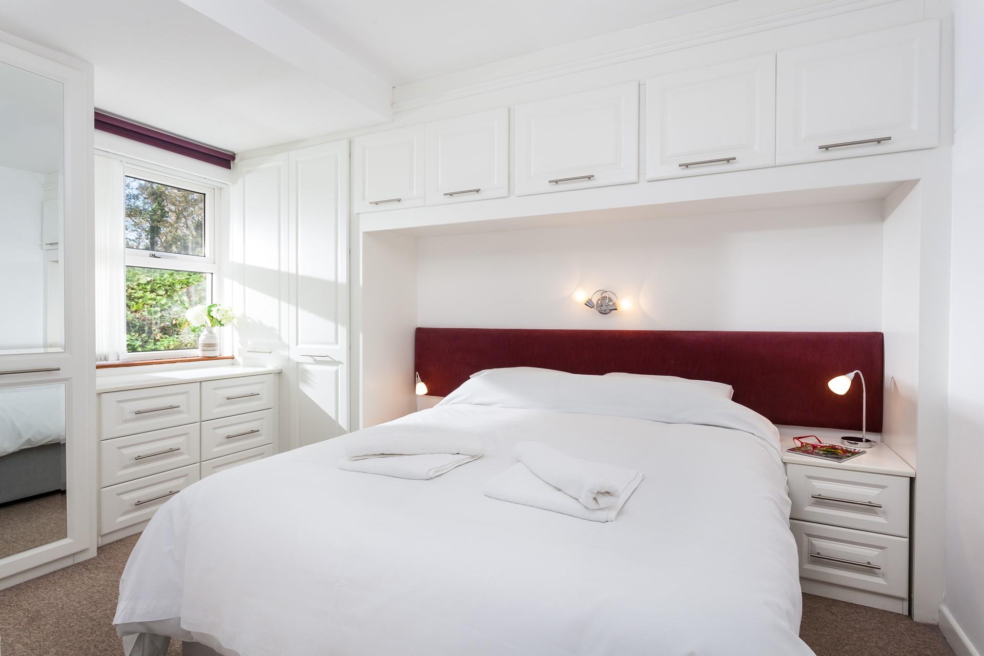The comfy bedroom offers a sumptuous bed and ample storage for all your holiday best.