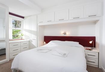 The comfy bedroom offers a sumptuous bed and ample storage for all your holiday best.