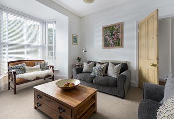 The sitting room area has a large bay window that fills the sitting room with light.
