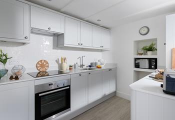 The kitchen has a modern style and is fully equipped to cook up a storm.