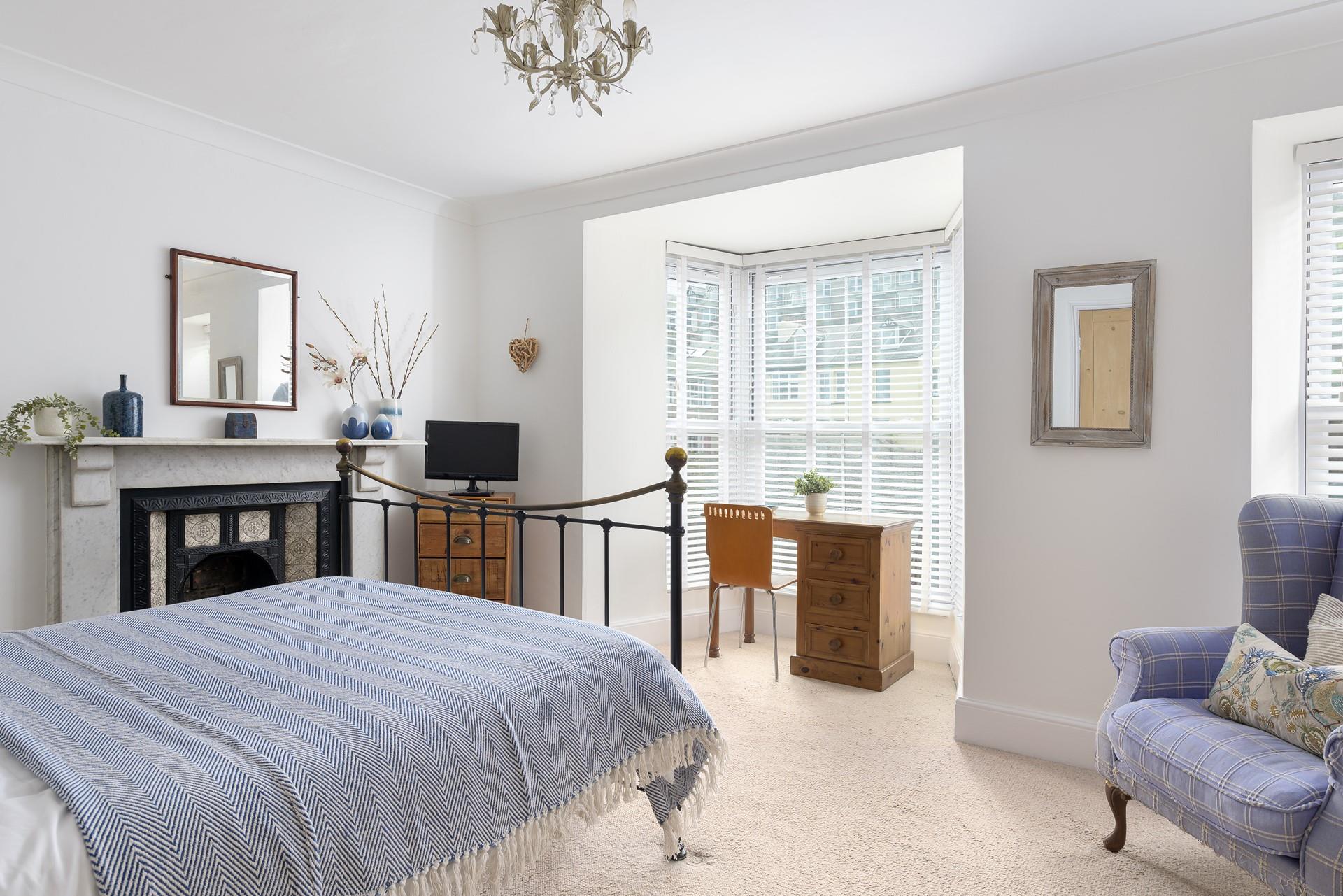 Bedroom 1 has metal filigree bedside glass top tables with ceramic bedside lamps.