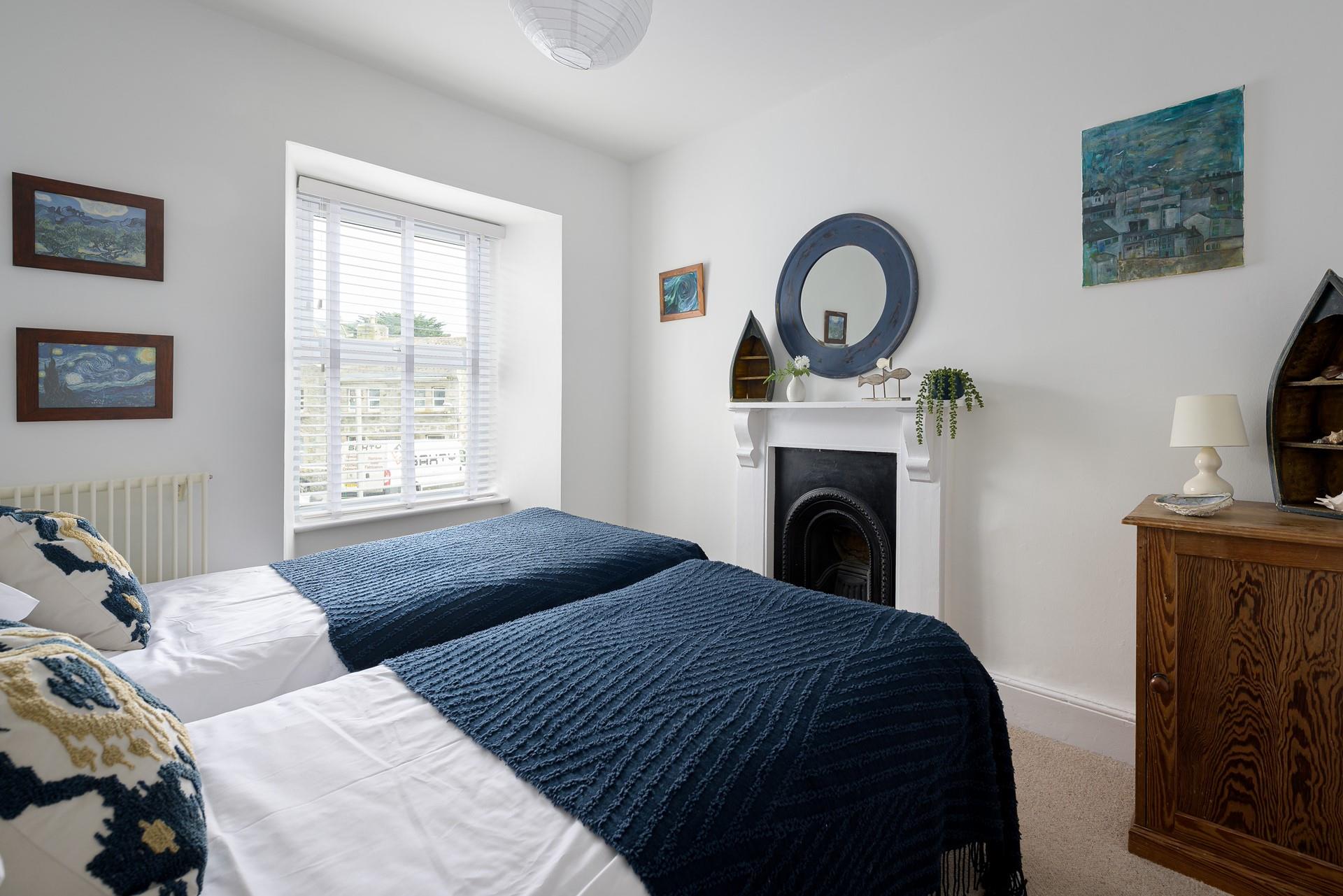 Bedroom 2 has twin beds perfect for adults and children to tuck into each night.