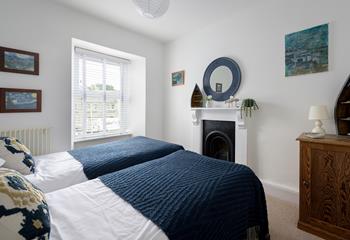 Bedroom 2 has twin beds perfect for adults and children to tuck into each night.