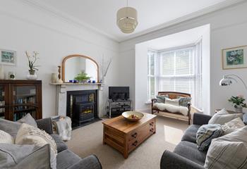 The sitting room is a gorgeous space to relax with a lovely period fireplace.