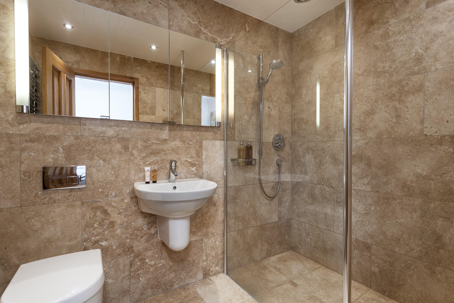 The bathroom benefits from a large walk-in shower, perfect for rinsing away the sand after a day on the beach!