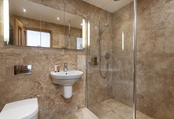 The bathroom benefits from a large walk-in shower, perfect for rinsing away the sand after a day on the beach!