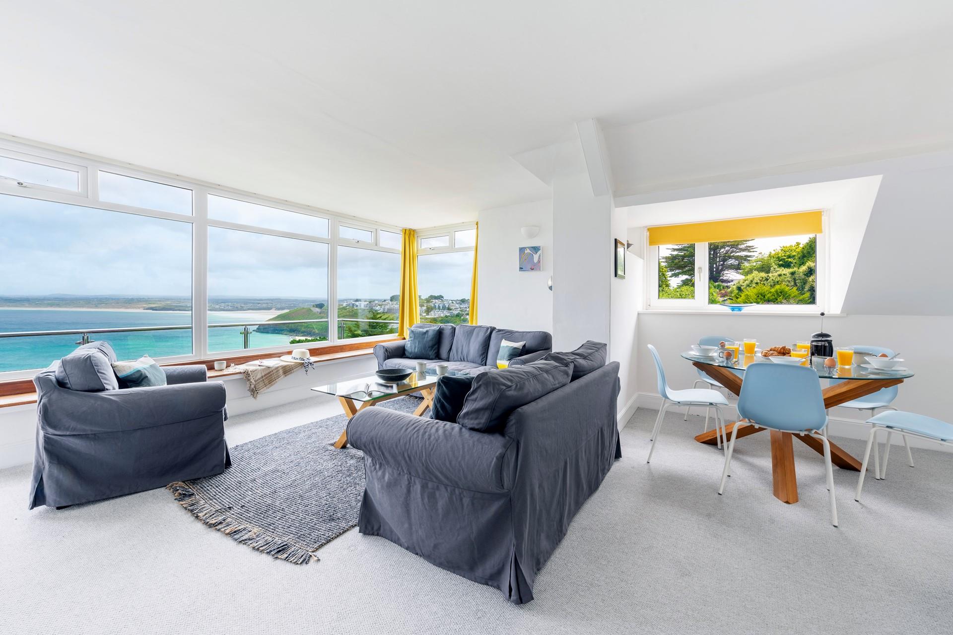 Bright and airy, the open plan sitting and dining room has plenty of space to gather together and make holiday plans. 